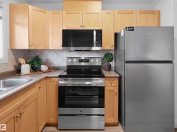 Kitchen featuring light wood cabinetry and neutral countertops - 