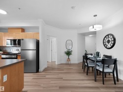 Open-concept kitchen and dining area featuring wood-finish flooring - 