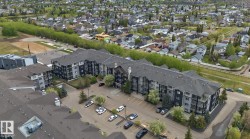 Multi-story apartment building featuring dark grey siding and light grey accents - 