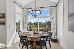 Dining area with a vaulted ceiling and a contemporary chandelier - 
