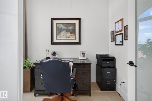 Dedicated workspace featuring light-toned flooring, white walls, and an arched glass panel door - 14 Jane Point(E), St. Albert, AB 