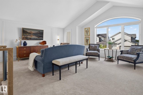 Spacious upper-level room featuring a vaulted ceiling and a large arched window - 14 Jane Point(E), St. Albert, AB 