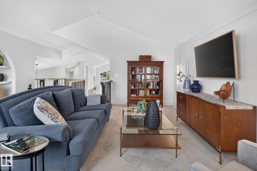 Living area featuring a textured carpet, light-colored walls, and a vaulted ceiling - 14 Jane Point(E), St. Albert, AB 