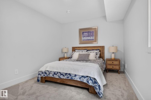 Spacious room featuring light-toned carpeting, ample natural light from a side window, and recessed ceiling lighting - 14 Jane Point(E), St. Albert, AB 