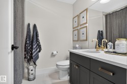 White vanity countertop with an integrated sink and brass-finish fixtures - 