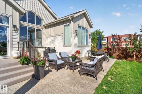 Exterior patio with a concrete surface, featuring a composite deck with stairs and aluminum railings - 14 Jane Point(E), St. Albert, AB 