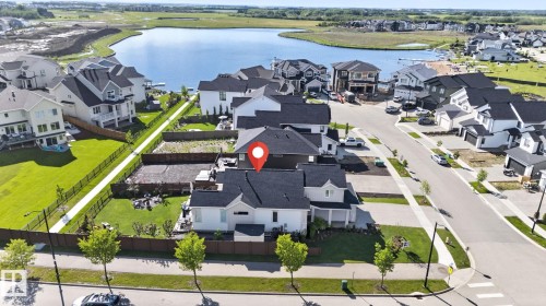 Modern suburban residence featuring a prominent black roof and white siding - 14 Jane Point(E), St. Albert, AB 
