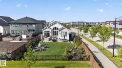 Contemporary light-toned exterior with a prominent arched window feature - 