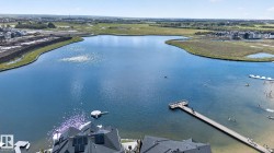 Expansive lakefront property featuring a long pier, a floating dock, and shoreline access - 