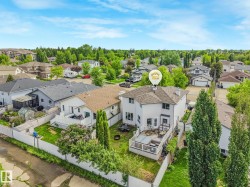 Backyard featuring a multi-level deck, fenced perimeter, and mature trees - 
