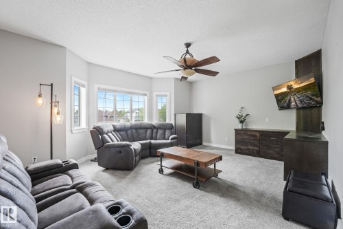 Living area featuring light gray walls and plush gray carpeting - 98 Bridgeport Wynd, Leduc, AB 