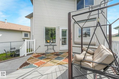 Expansive outdoor deck featuring wood-finish flooring, white railing, and exterior siding - 98 Bridgeport Wynd, Leduc, AB 