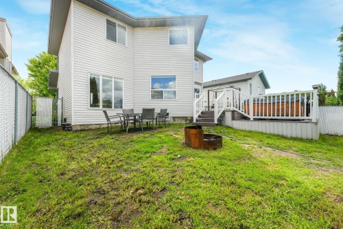 Spacious backyard featuring a multi-level deck, integrated hot tub, and a fire pit - 98 Bridgeport Wynd, Leduc, AB 