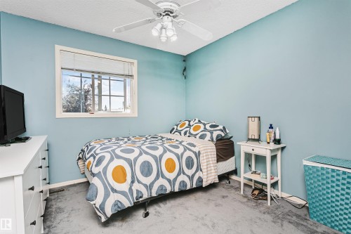 Room featuring a single window with blinds, light blue walls, and grey carpet flooring - 1612 80A Street, Edmonton, AB 