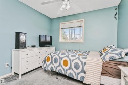 Light blue walls define this space, featuring a window with a white frame and horizontal blinds - 