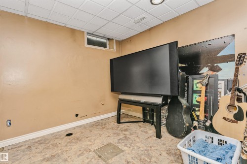 Room featuring a drop ceiling, single window, and light-toned walls - 1612 80A Street, Edmonton, AB 