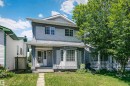 Stucco exterior with a covered porch featuring decorative columns - 1612 80A Street, Edmonton, AB 