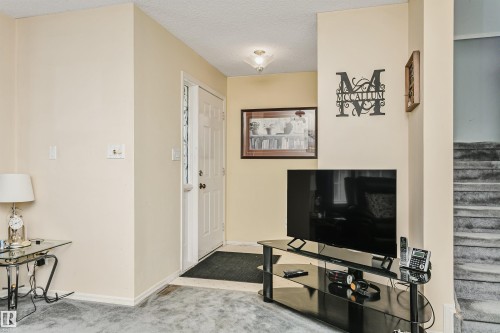 Entryway featuring a paneled door, ceiling-mounted light fixture, and tile flooring - 1612 80A Street, Edmonton, AB 