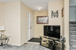 Entryway featuring a paneled door, ceiling-mounted light fixture, and tile flooring - 