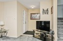 Entryway featuring a paneled door, ceiling-mounted light fixture, and tile flooring - 1612 80A Street, Edmonton, AB 