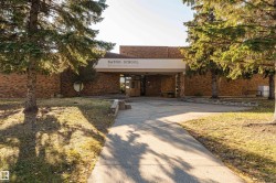 Brick exterior featuring a prominent covered entrance - 
