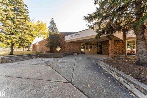 Brick exterior building featuring multiple entryways and large windows - 1612 80A Street, Edmonton, AB 
