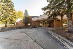 Brick exterior building featuring multiple entryways and large windows - 