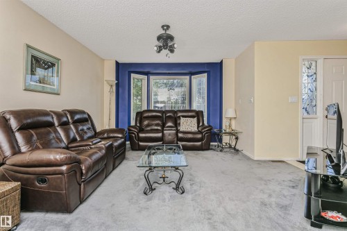 Interior space featuring light-colored walls and a textured ceiling - 1612 80A Street, Edmonton, AB 