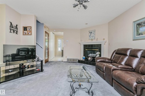 Living area with light-colored walls and grey carpeting - 1612 80A Street, Edmonton, AB 