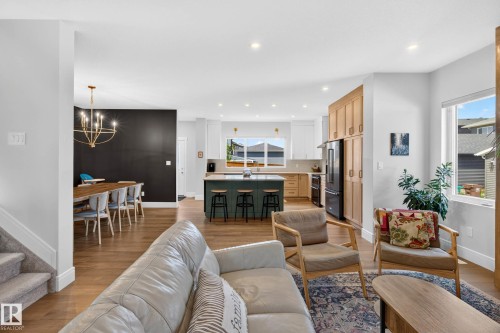 Open-concept living space with wood-finish flooring throughout - 30 Rosewood Way, St. Albert, AB 