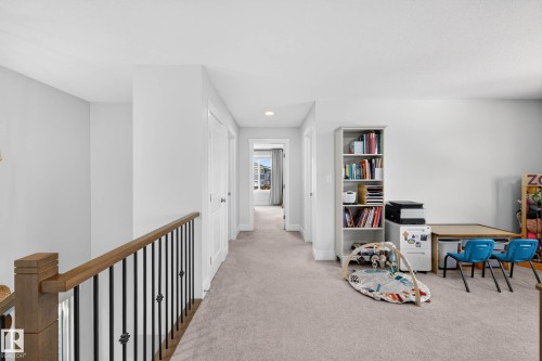 Spacious carpeted hallway featuring white walls and trim - 30 Rosewood Way, St. Albert, AB 