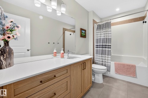 Bathroom featuring a light wood-finish vanity with a white countertop and rectangular undermount sink - 30 Rosewood Way, St. Albert, AB 