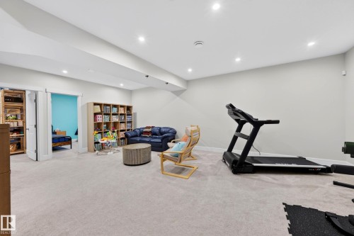 Spacious carpeted room featuring recessed lighting and light-toned walls - 30 Rosewood Way, St. Albert, AB 