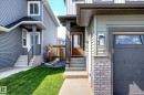 Modern façade featuring light green siding with dark trim accents - 30 Rosewood Way, St. Albert, AB 