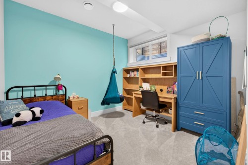Room featuring light blue accent wall and neutral carpeting - 30 Rosewood Way, St. Albert, AB 