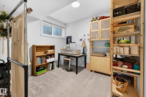 Carpeted interior space featuring a window with blinds, recessed lighting, and light gray wall paint - 30 Rosewood Way, St. Albert, AB 