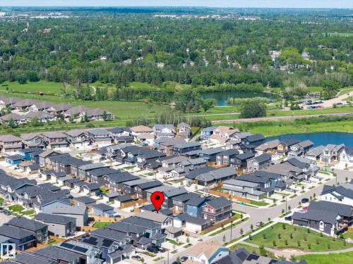 Aerial perspective showcasing a residential community with a large green space and bodies of water - 30 Rosewood Way, St. Albert, AB 