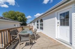 Expansive wood deck with a full wood railing system, providing outdoor living space - 