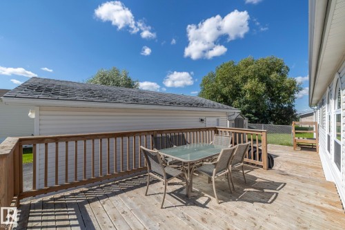 Expansive wood-finish deck featuring a wood railing - 143 48 3400 Street W, Stony Plain, AB 