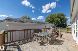 Expansive wood-finish deck featuring a wood railing - 