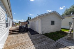 Expansive wood-finish deck with steps leading to an elevated platform - 