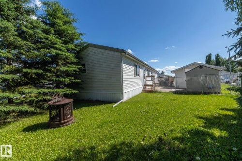Rear exterior featuring white horizontal siding and a dark roofline - 143 48 3400 Street W, Stony Plain, AB 