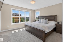 Carpeted bedroom with a large multi-pane window and a smaller single-pane window - 