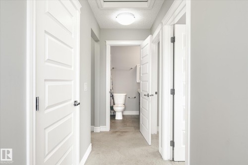 Hallway with light gray walls and plush carpeting - 47 330 Bulyea Road, Edmonton, AB - Indoor Photo Showing Bathroom