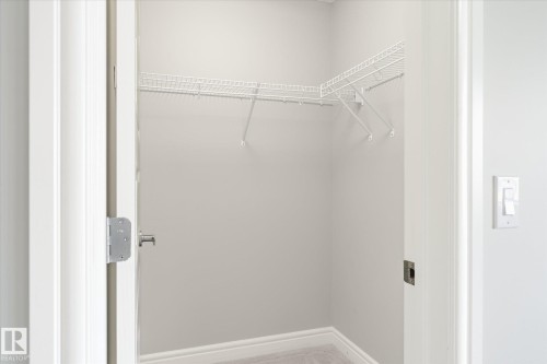 Utility closet featuring wire shelving, light gray wall paint, white trim, and light-colored flooring - 47 330 Bulyea Road, Edmonton, AB - Indoor With Storage