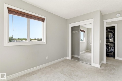 Room featuring light-toned carpeting and a double window with wood-tone blinds - 47 330 Bulyea Road, Edmonton, AB - Indoor Photo Showing Other Room