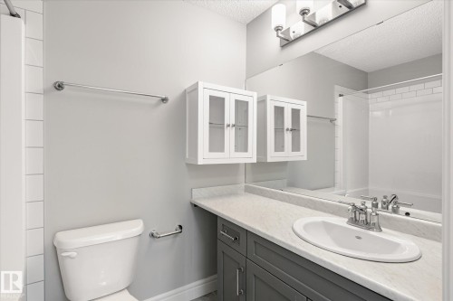 Bathroom featuring a vanity with a light-toned countertop, an integrated sink, and a chrome faucet - 47 330 Bulyea Road, Edmonton, AB - Indoor Photo Showing Bathroom
