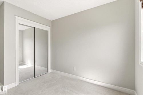 Room featuring light gray wall paint, white trim, and light gray carpet - 47 330 Bulyea Road, Edmonton, AB - Indoor Photo Showing Other Room
