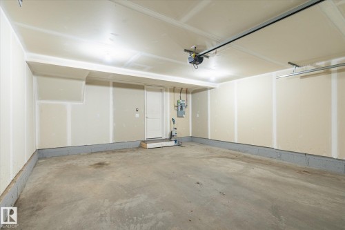 Spacious garage with concrete flooring and exposed drywall - 47 330 Bulyea Road, Edmonton, AB - Indoor Photo Showing Garage