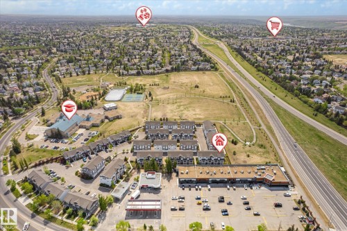 Aerial view showcasing a residential community with multi-story townhomes and single-family residences - 47 330 Bulyea Road, Edmonton, AB -  With View